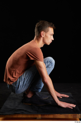 Alessandro Katz  black shoes blue jeans brown t shirt casual dressed kneeling whole body  jpg